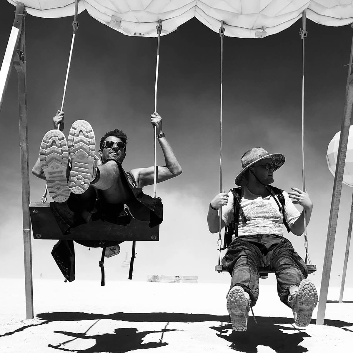 monochrome-photo-of-men-on-swing-2889967